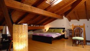 a bedroom with a bed in a room with wooden ceilings at B&B Via Punta 8 in Bologna