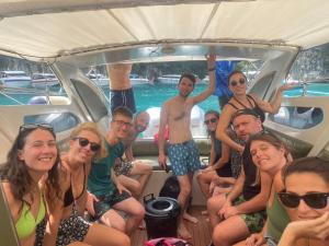a group of people sitting in the back of a boat at The Sunshine hostel and hotel in Ko Lanta