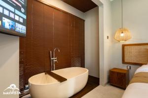 a bath tub in a room with a window at Soocha B by Bukit Vista in Ungasan +28 photos