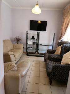 a living room with two couches and a flat screen tv at 850 Munro in Margate