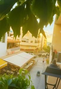 a building with a courtyard with tables and chairs at Arguinegin Gran Canaria Near the Beach with ocean view in Arguineguín