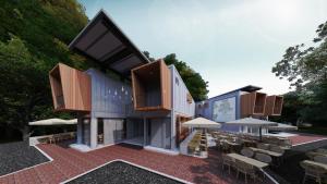 een gebouw met stoelen, tafels en parasols bij ClubRock Perlis in Kaki Bukit