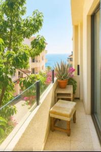 a balcony with a bench and a view of the ocean at Arguinegin Gran Canaria Near the Beach with ocean view in Arguineguín