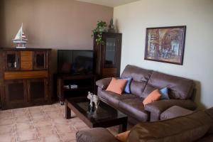 a living room with a couch and a tv at Casa José in La Herradura