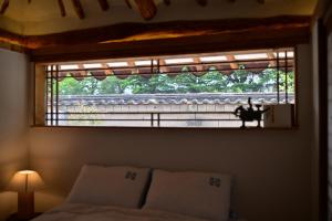 a window in a room with a bed and a bed sidx sidx sidx at 사다함 SaDaHam in Gyeongju