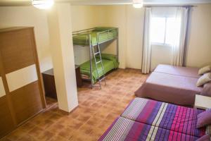 a room with two beds and a bunk bed at Casa José in La Herradura