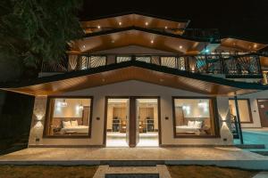 a house with a balcony with a pool at The Aralia in Dehradun