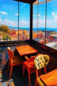 een tafel en stoelen in een kamer met een groot raam bij Kaya-Royal-Hotel Beyazit Istanbul All Tea And Coffee Are Complimentary And Available 24-7 On Our Sea View Terrace Restaurant in Istanbul