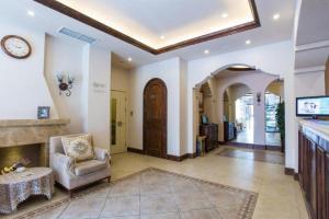 a living room with a chair and a fireplace at Jinjiang Inn Dalian Railway Station Russian Street in Dalian