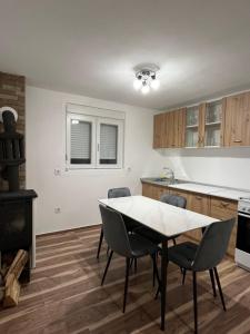 a kitchen with a table and chairs and a stove at Rakocevic house in Kolašin