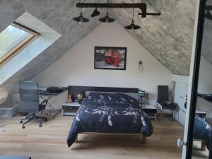 - une chambre mansardée avec un lit et un bureau dans l'établissement Gite Les Quatre Alouettes, à Mazières-de-Touraine 41 autres photos