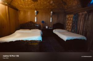 a room with two beds in a room with at Heritage Houseboat - Almost Heaven in Srinagar
