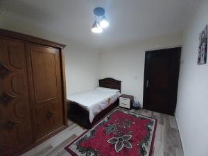 a bedroom with a bed and a door and a rug at Luxury Apartment In Sheikh Zayed - Jannah 2 Compound in Sheikh Zayed