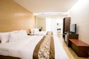 Ένα ή περισσότερα κρεβάτια σε δωμάτιο στο Huang Shin Business Hotel-Chung Kang
