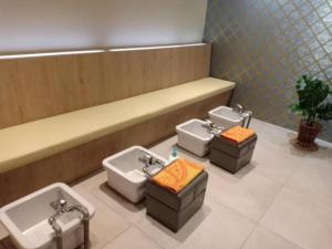 a bathroom with three sinks and three toilets at Twin Star Hotel in Kampong Keteyong +89 photos