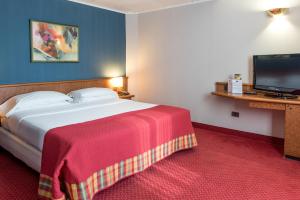 a hotel room with a bed and a flat screen tv at Idea Hotel Piacenza in Piacenza +53 photos