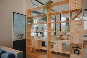 a room with a large wooden cabinet with glass doors at Bilik-Bilik by MUO in Seremban