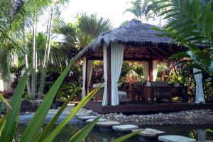 a gazebo with a pond in front of a resort at Forest Lodge: Bali-Style Retreat in Agnes Water