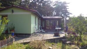 a small house with a porch and a patio at Bungalow am Küstrinsee bei Lychen in Lychen