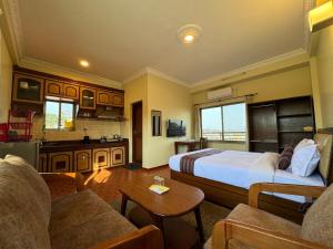 a hotel room with a bed and a living room at Tise Hotel in Kathmandu