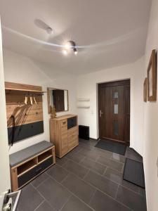 a living room with a flat screen tv and a couch at Ferienwohnung Auszeit am Waldrand in Olpe