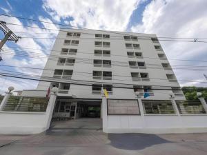 a large white building with a lot of windows at Next Bird Suite in Bangkok