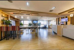 an office with a table and chairs in a room at 7 Days Premium Xi'an Dayan Tower Xiaozhai Metro Station in Xi'an