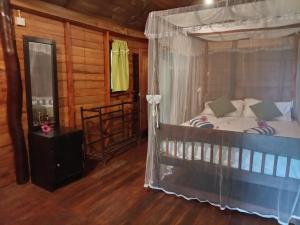 a bedroom with a canopy bed in a cabin at Echo retreat in Tangalle
