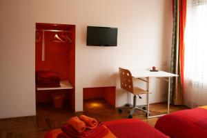 a room with a bed and a desk and a tv at B&B Loft Padova in Padova