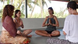 a group of women sitting on the floor in meditation at Borrbo Beach Hostel Gokarna in Gokarna