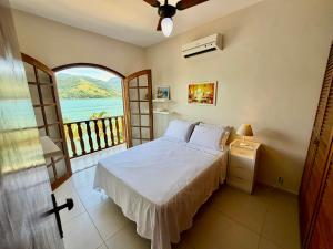 En eller flere senge i et værelse på Casa Sol de Mangaratiba