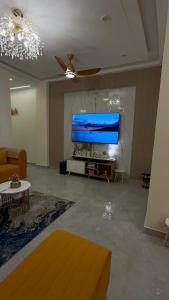a living room with a large flat screen tv at NIVAASe STAYS in New Delhi