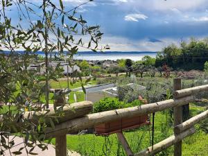 a wooden fence with a flower pot on it at Agricamping Est Garda Home Rubino in Lazise
