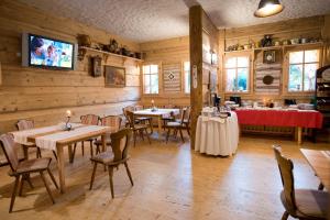 a restaurant with tables and chairs and a tv on the wall at Zajazd Polonez in Dębica