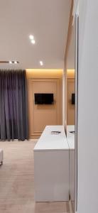 a room with a white counter in a room with curtains at HOTEL KRISTAL in Vlorë