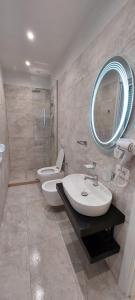 a bathroom with two toilets and a sink and a mirror at HOTEL KRISTAL in Vlorë +70 photos