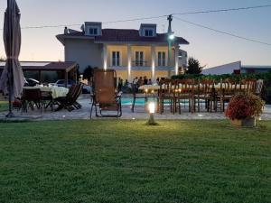 a yard with chairs and tables and a house at Villa Miranda in Ortona