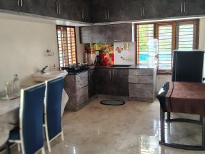 a kitchen with a sink and a counter top at Blue Moon Homestay in Mysore