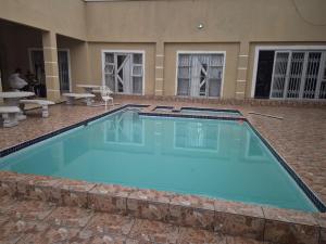 a large swimming pool in the middle of a building at Morogoro Park Lodge 