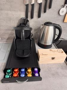 a tea kettle and a box of buttons on a counter at Apartment SNOW in Bruck an der Mur