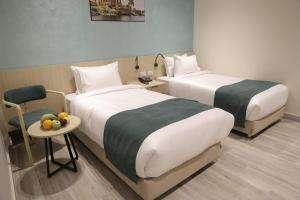 a hotel room with two beds and a table with fruit on it at Solpyramid Hotel in Cairo
