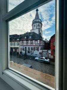 ein Blick aus dem Fenster eines Gebäudes mit einem Glockenturm in der Unterkunft Elegant Studio in Gengenbach Old Town with Tower View in Gengenbach + 3 Fotos