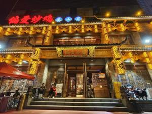 a building with people standing in front of it at MountTai Twilight Elegance Lodge in Tai'an