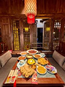 a table with many plates of food on it at MountTai Twilight Elegance Lodge in Tai'an