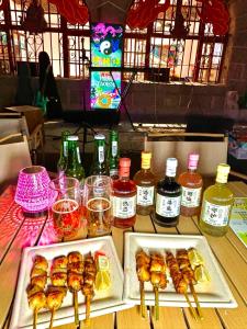 a table topped with plates of food and bottles of alcohol at MountTai Twilight Elegance Lodge in Tai'an +41 photos