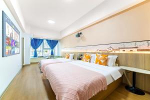 two beds in a room with blue curtains at MountTai Twilight Elegance Lodge in Tai'an