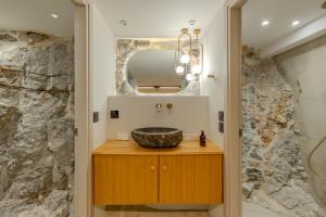 a bathroom with a sink and a mirror at Onora Suites Nafplio in Nafplio +82 photos