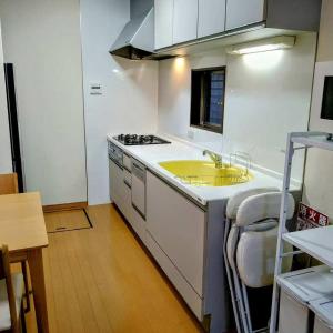 a kitchen with a sink and a stove at 京旅别莊 in Kyoto
