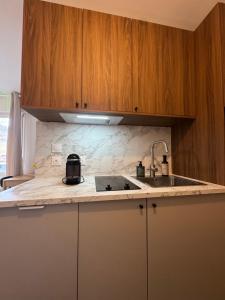 a kitchen with a sink and a counter top at Charming studio with balcony in Samoëns