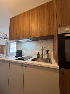 a kitchen with a sink and a microwave at Charming studio with balcony in Samoëns